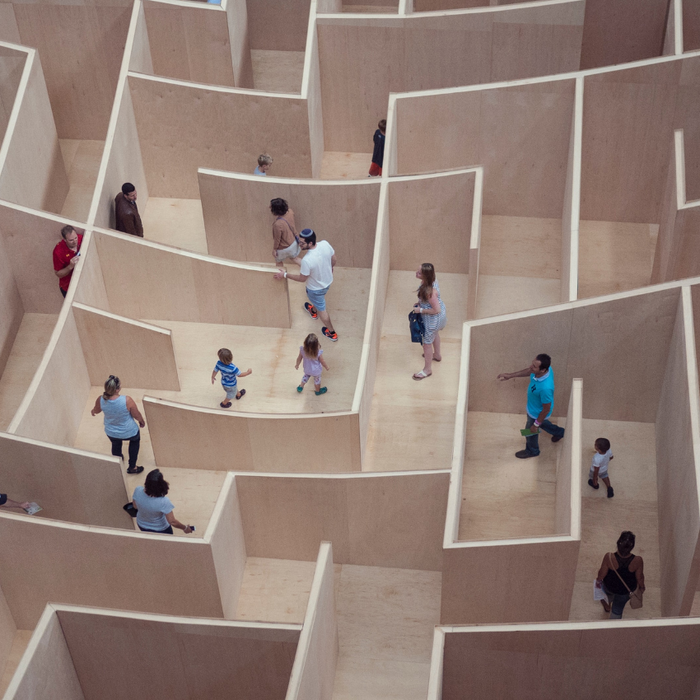 people walking around a large maze