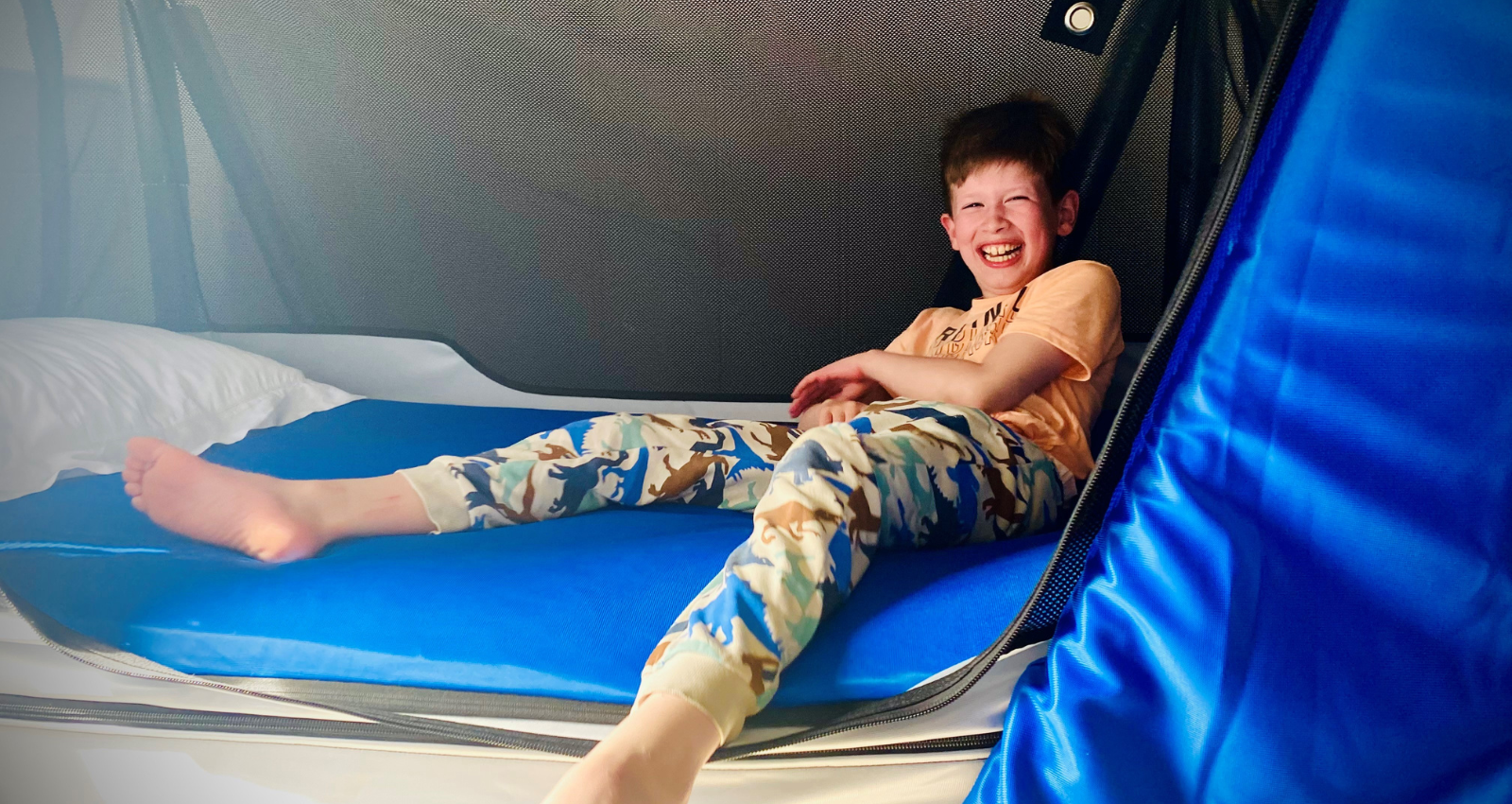 Smiling boy laying on specialist safety bed